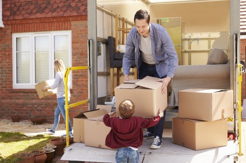 Professional movers loading items into a removals van