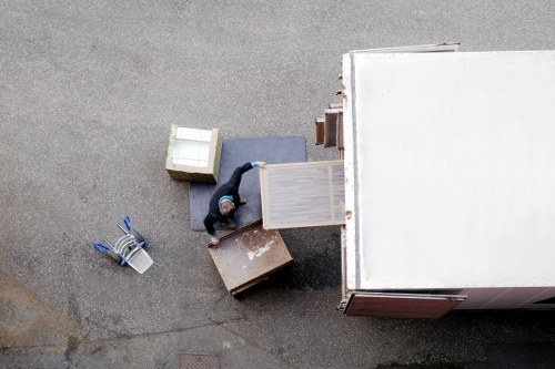 Careful wrapping of fragile household items during a packing service in West Ham