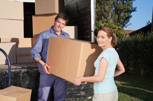 Packed moving boxes and furniture ready for transport in West Ham